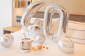 a silver balloons on a bed