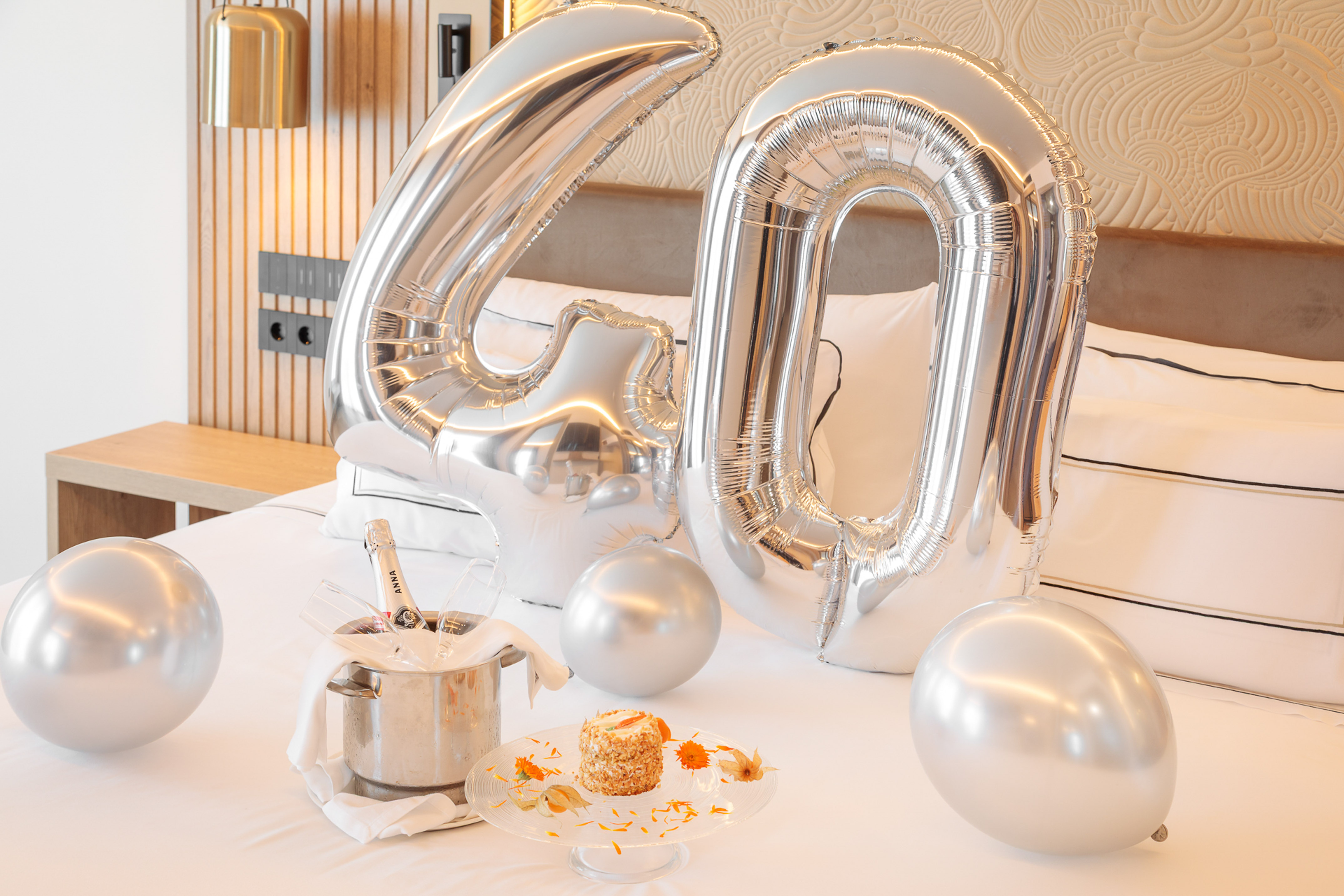 a silver balloons on a bed