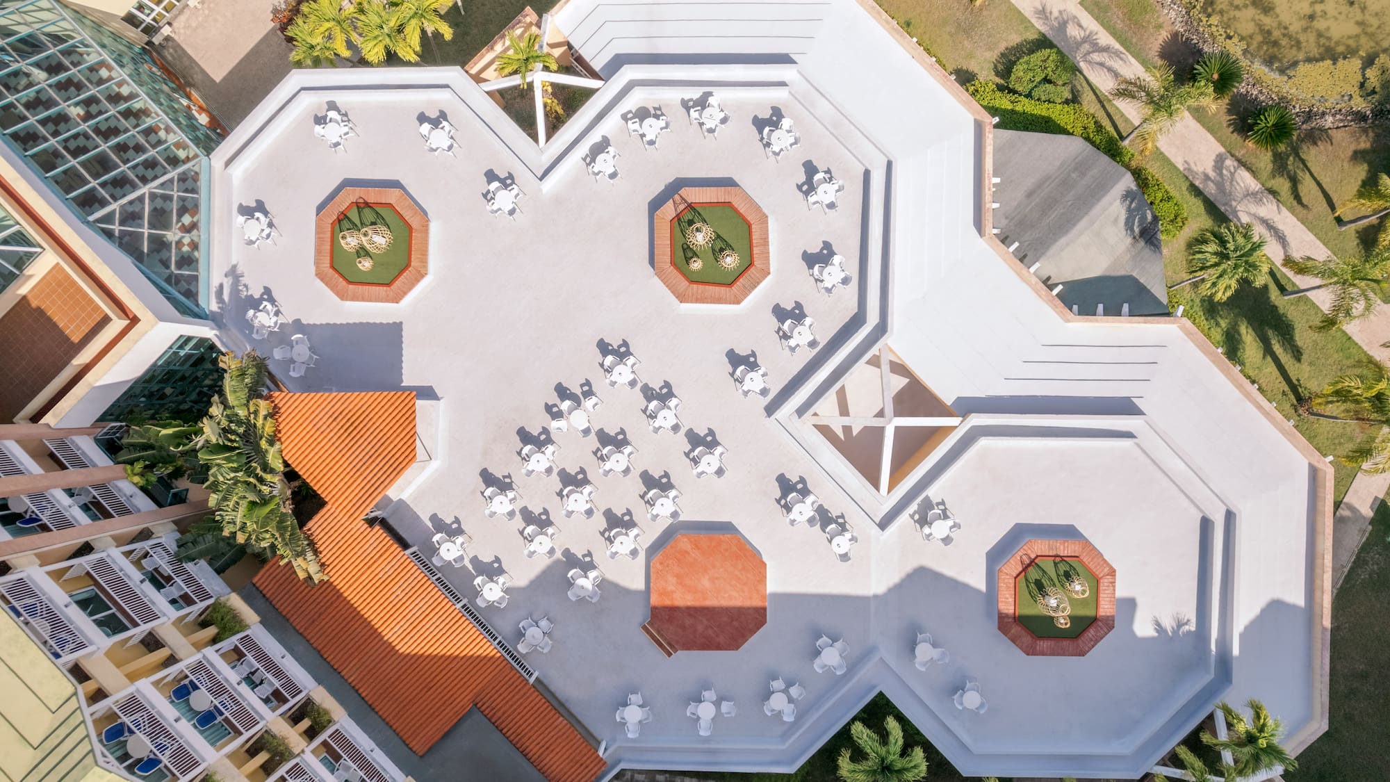 an aerial view of a building with tables and chairs