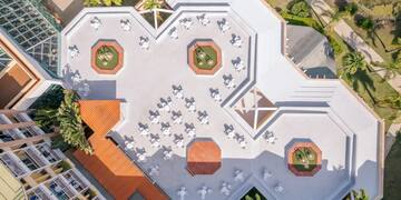 an aerial view of a building with tables and chairs