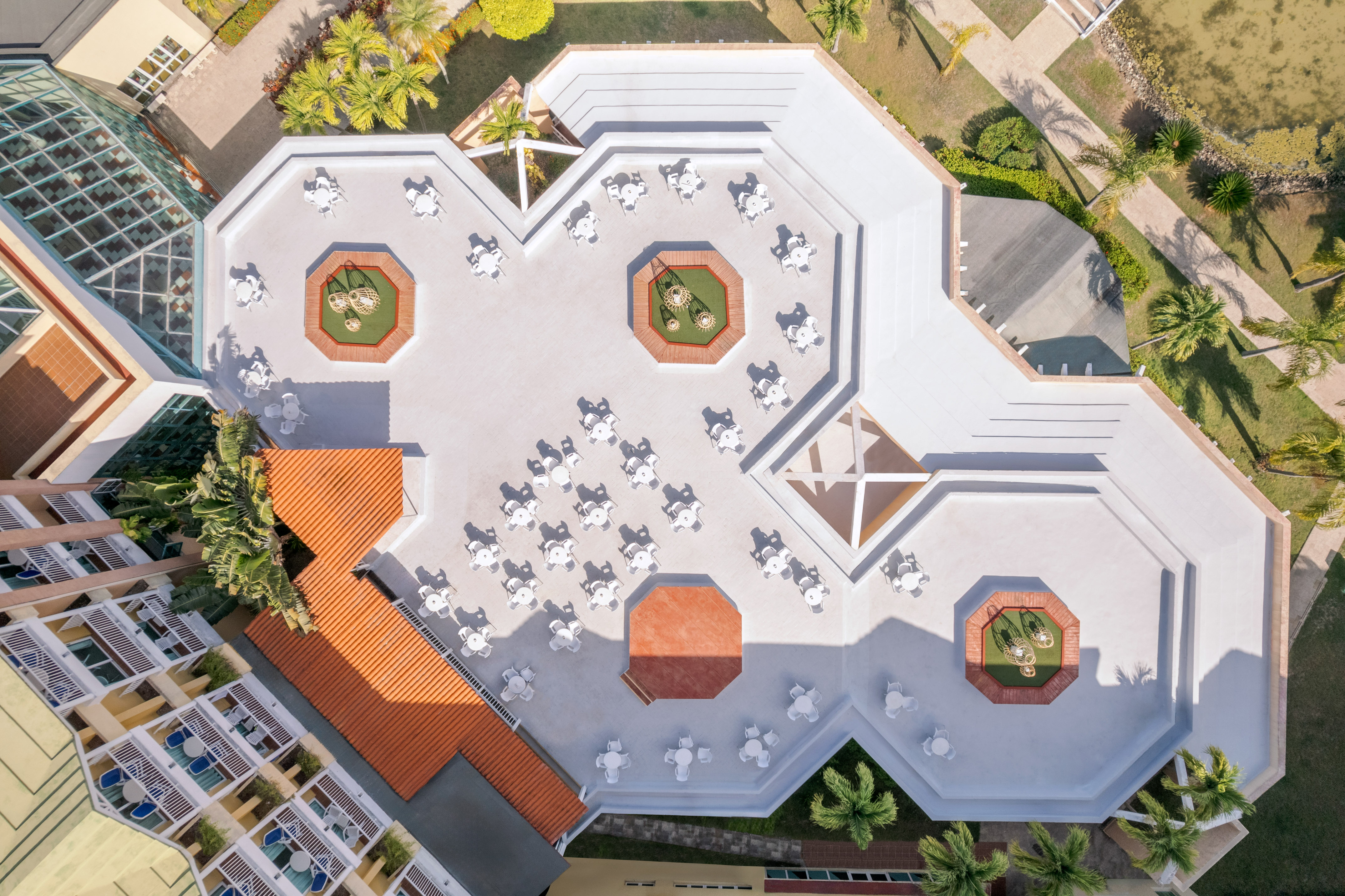 an aerial view of a building with tables and chairs