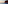 Sailboat cruising along dramatic ocean cliffs at sunset