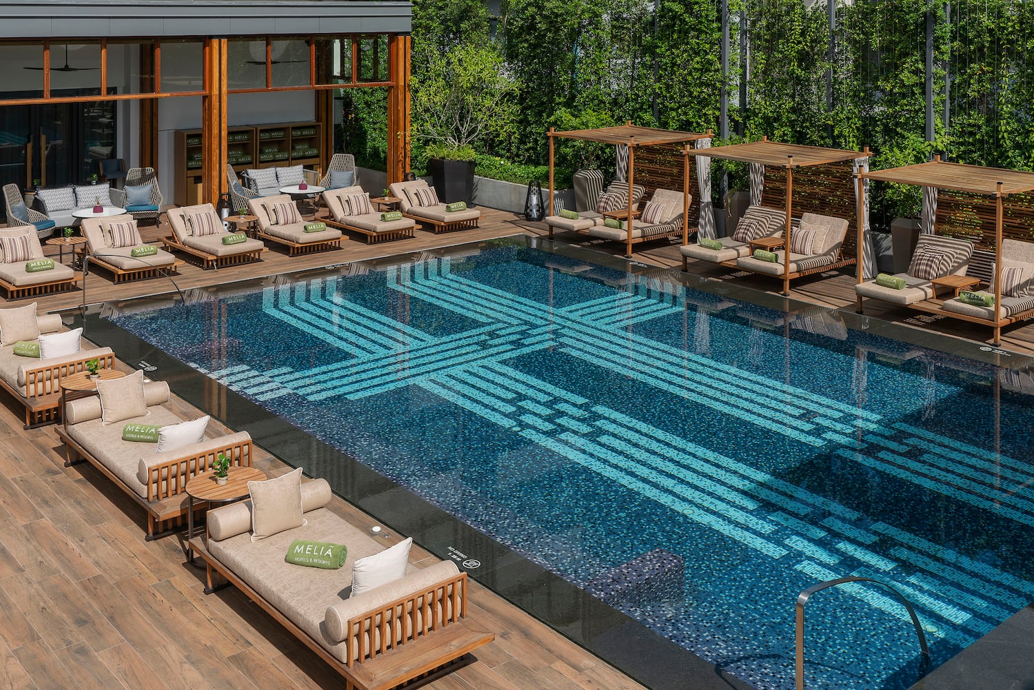 a pool with lounge chairs and a deck
