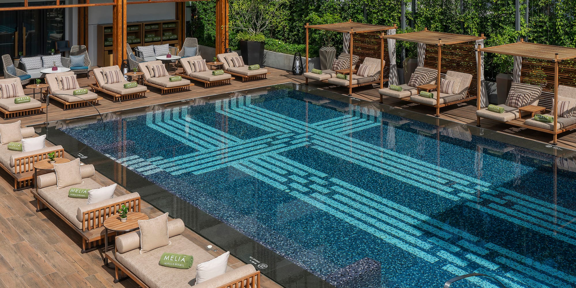 a pool with lounge chairs and a deck