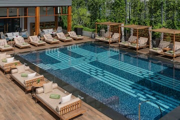 a pool with lounge chairs and a deck
