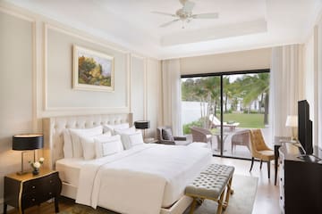 a bedroom with a large bed and a glass door