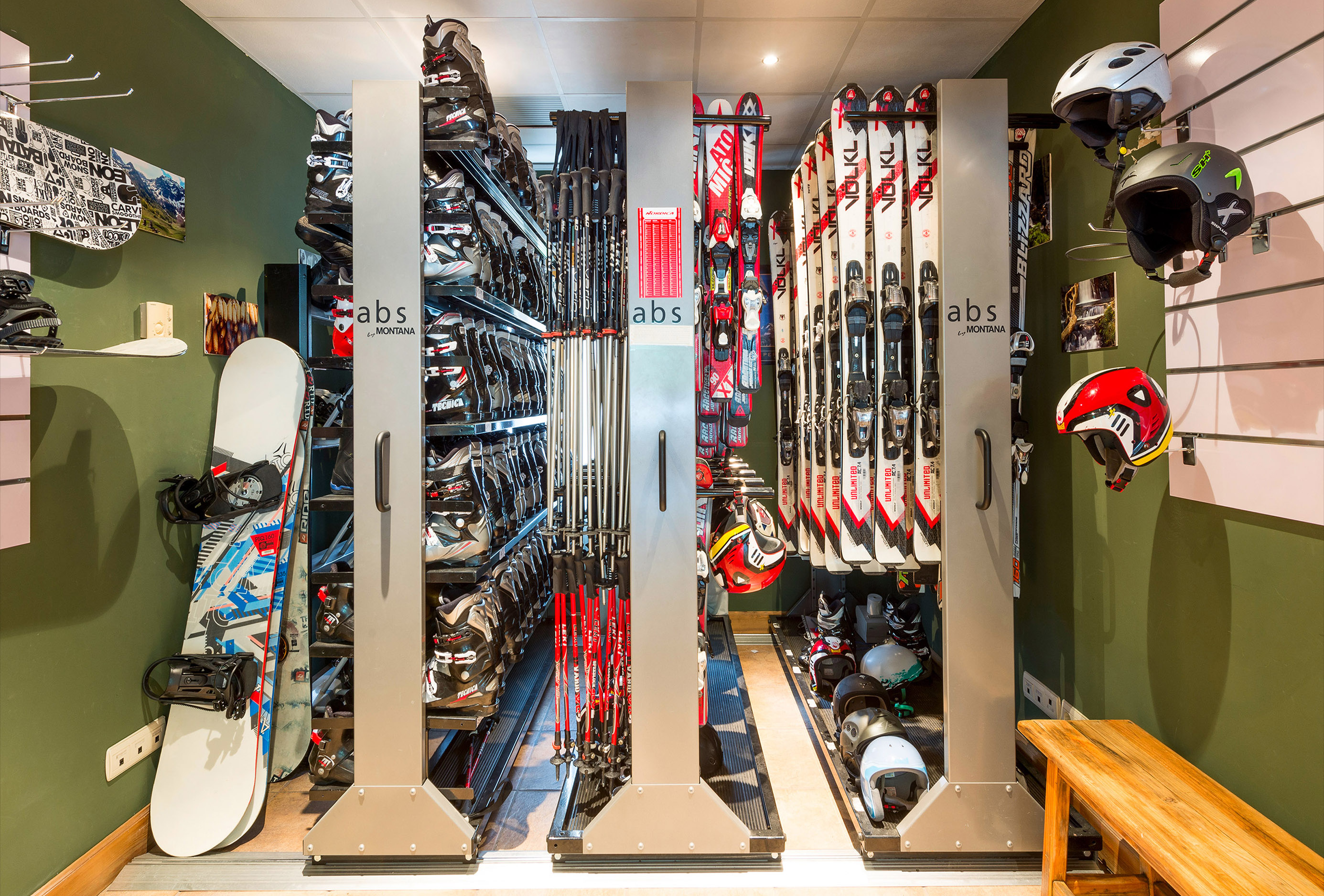 a rack of skis and helmets
