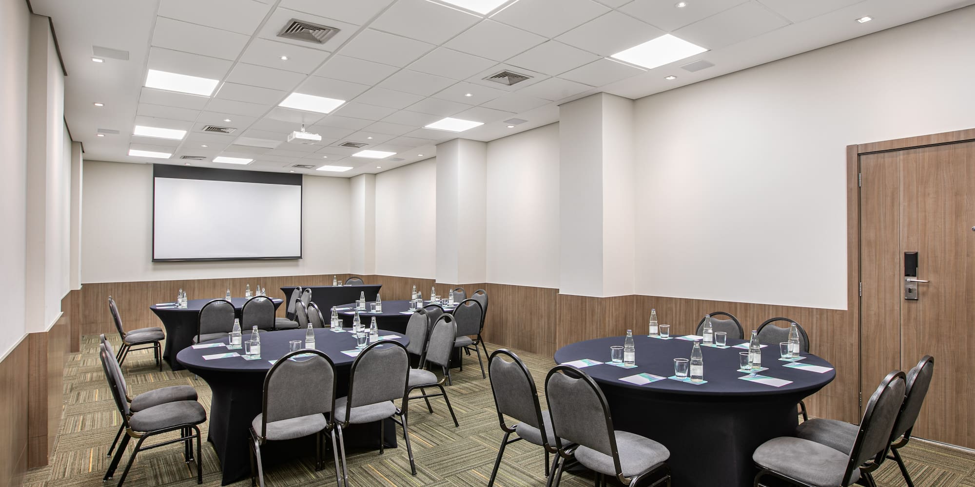 a room with round tables and chairs