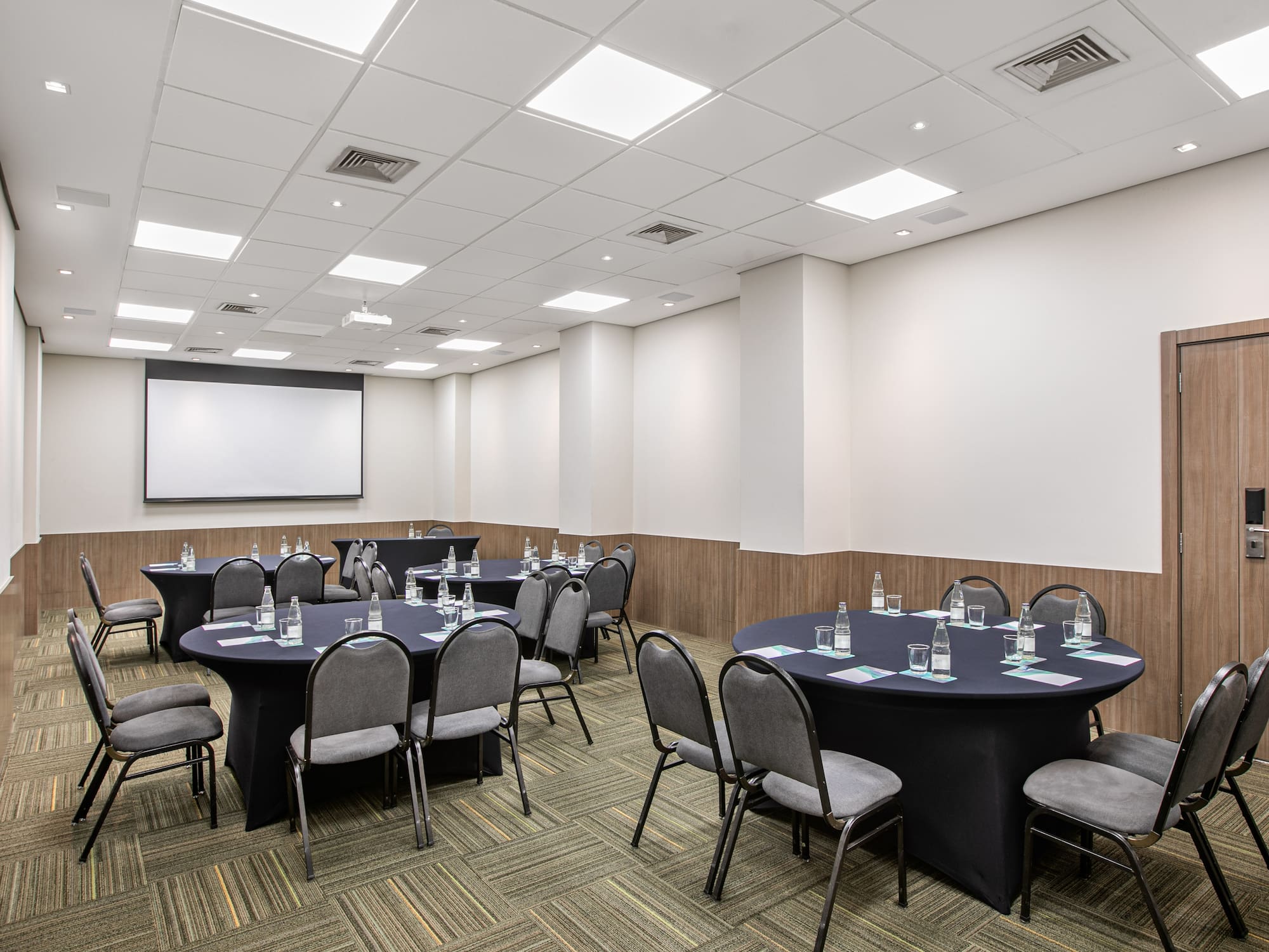 a room with round tables and chairs