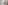 Modern bathroom with white bathtub, wooden vanity, sink, and glass partition.