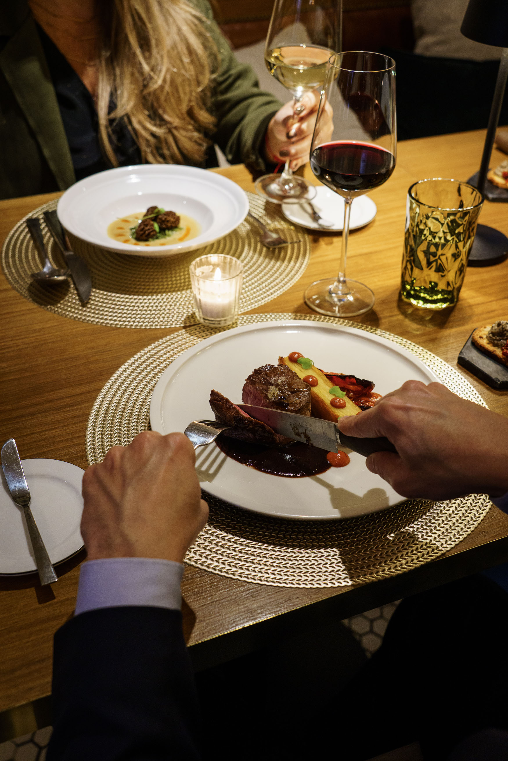 a person cutting food on a plate