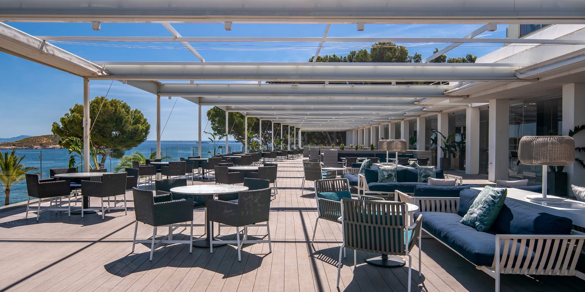 a patio with chairs and tables on a deck