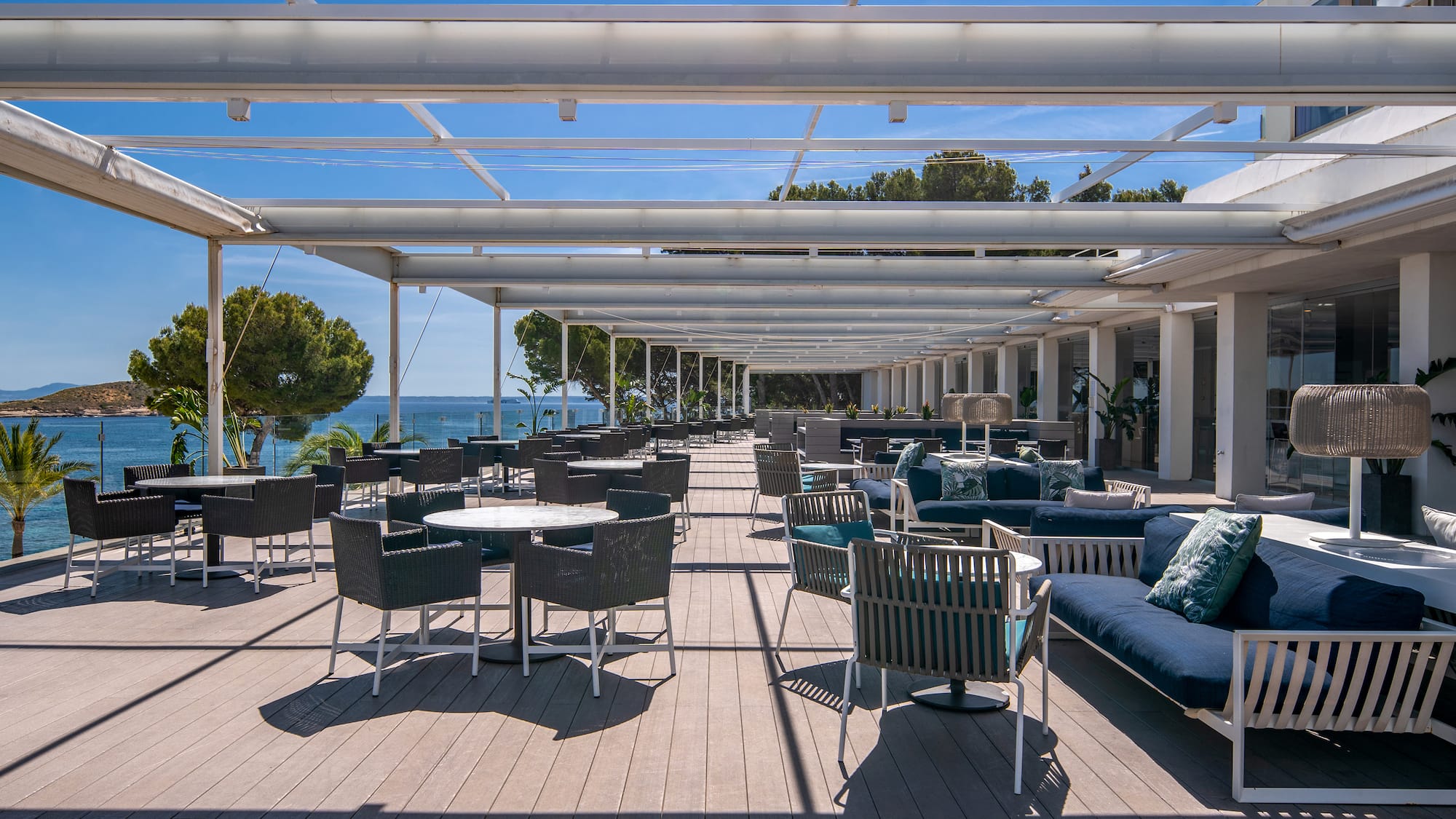 a patio with chairs and tables on a deck
