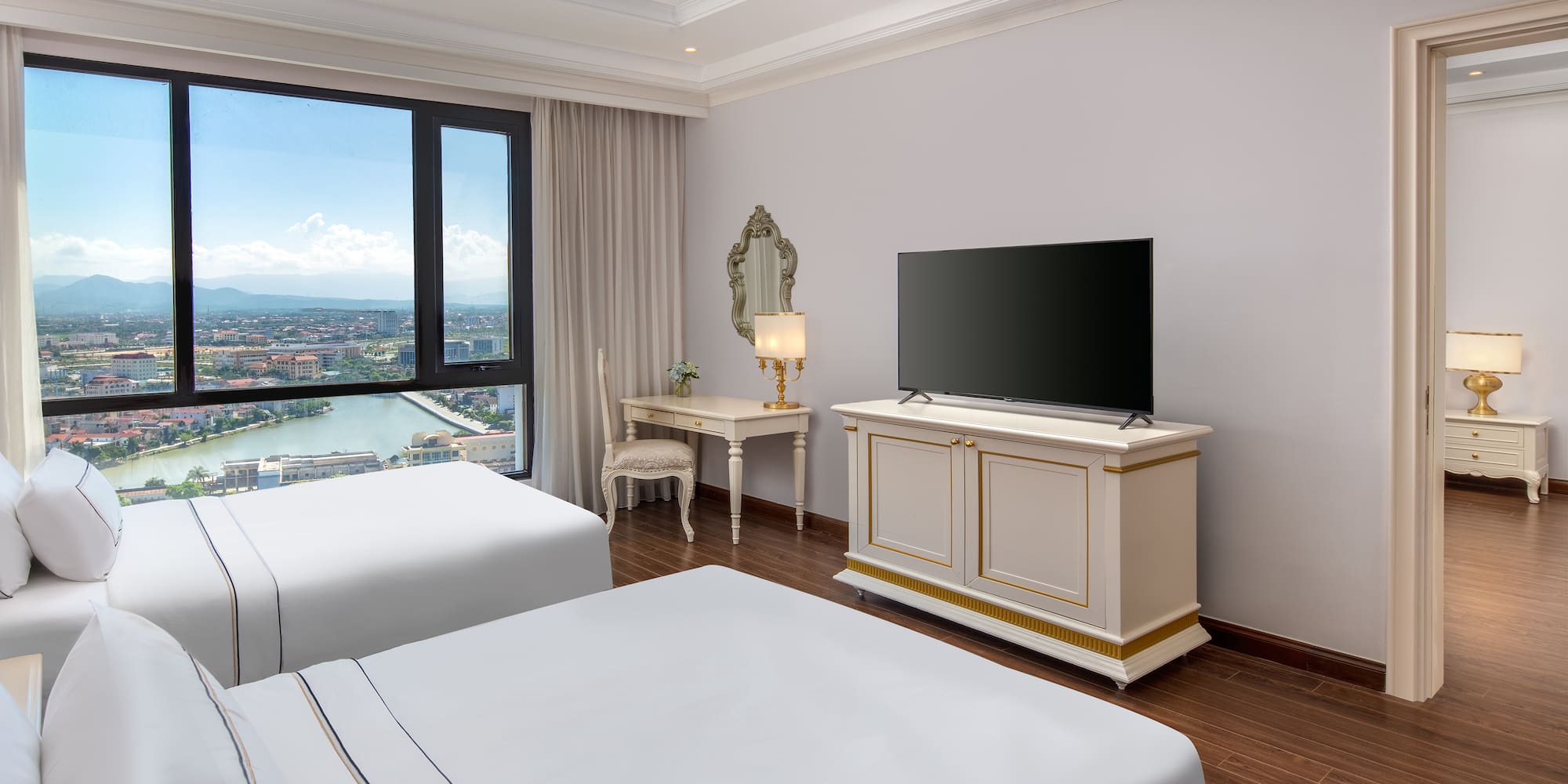 a room with two beds and a television