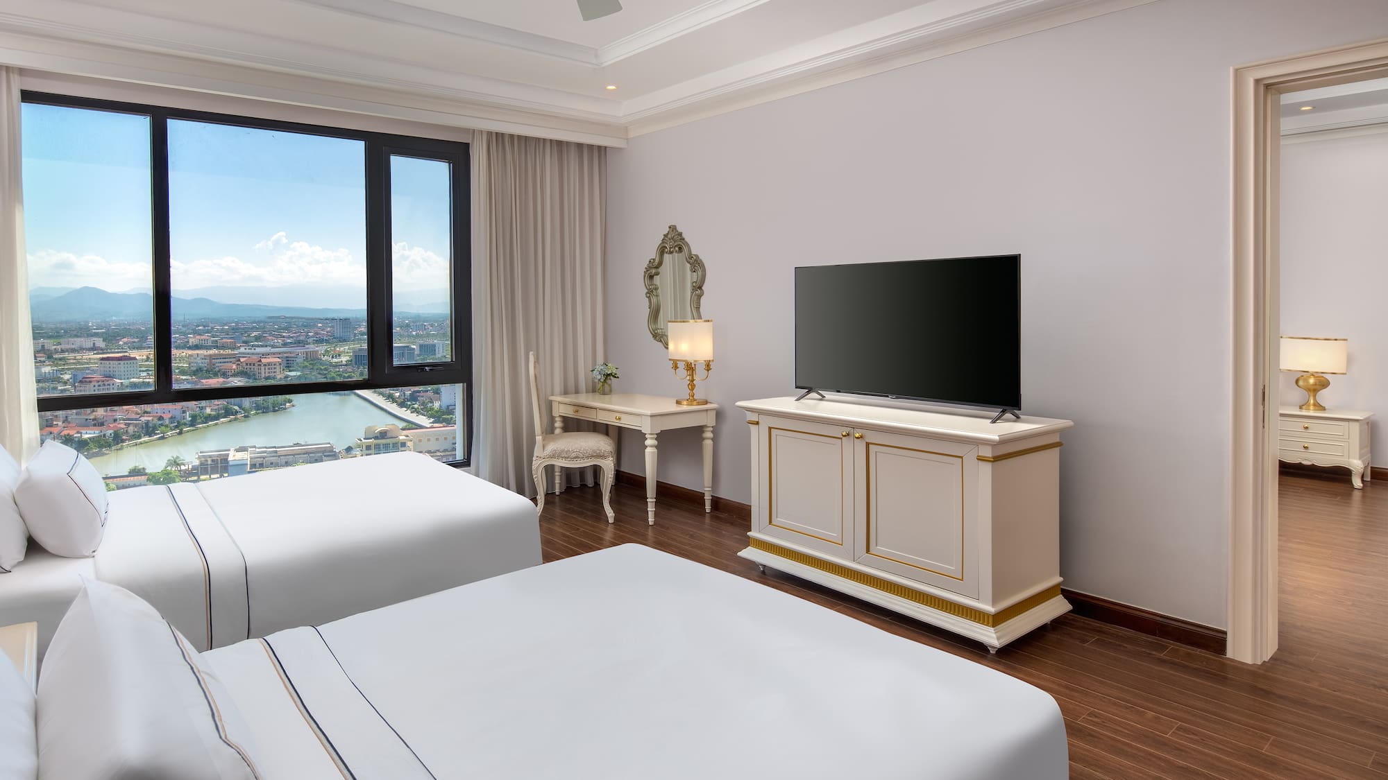 a room with two beds and a television