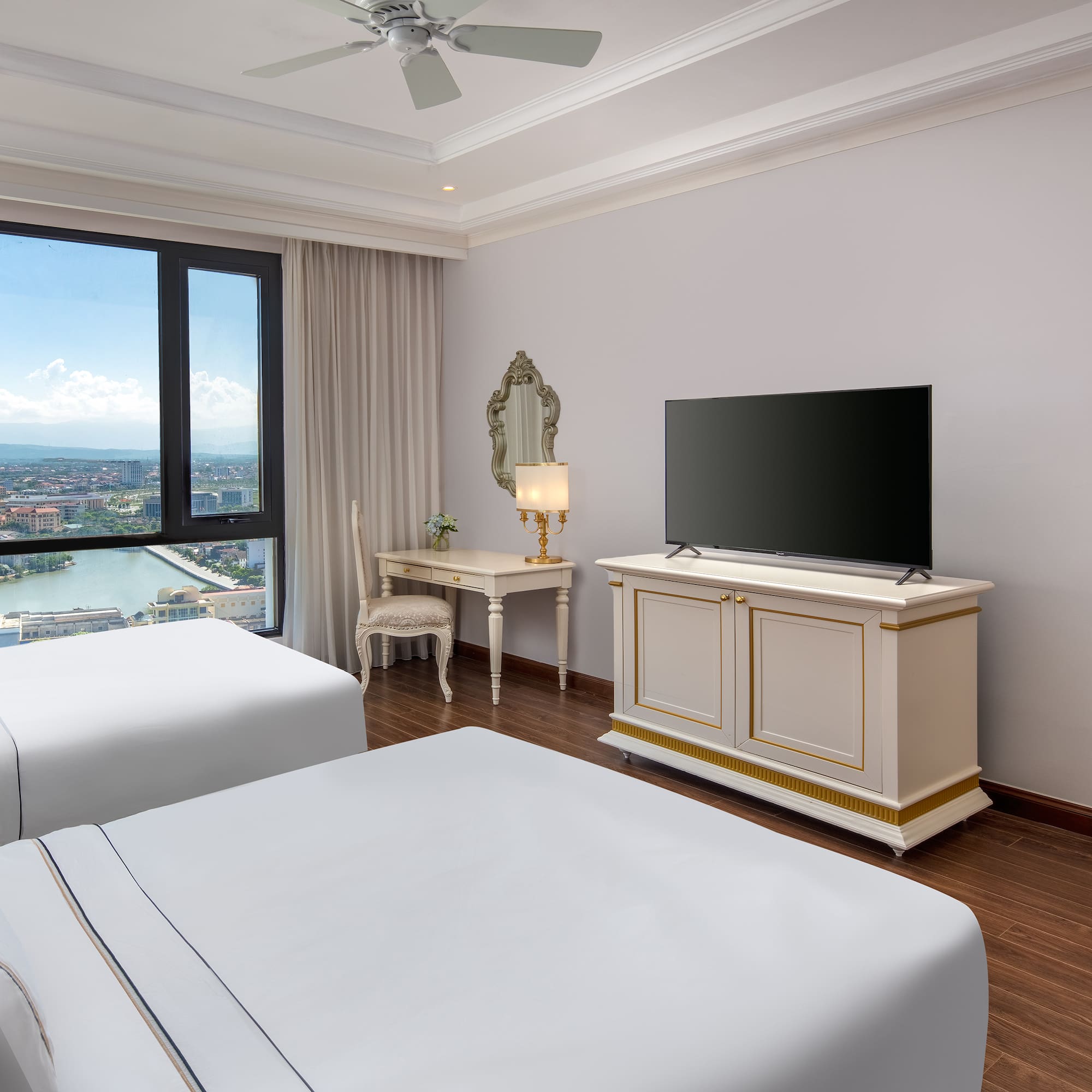 a room with two beds and a television