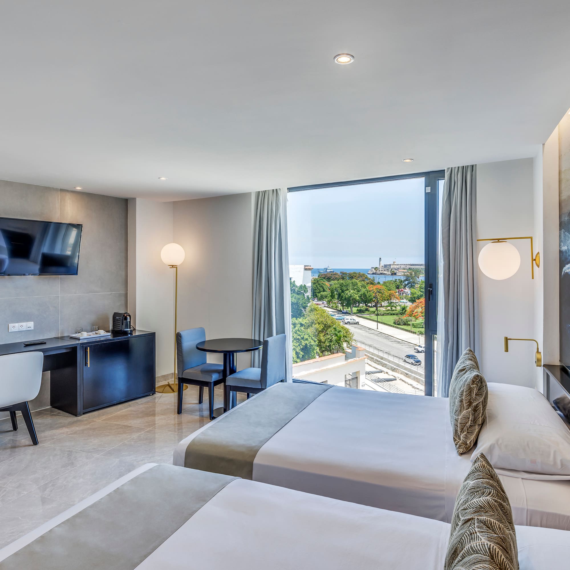 a room with two beds and a television