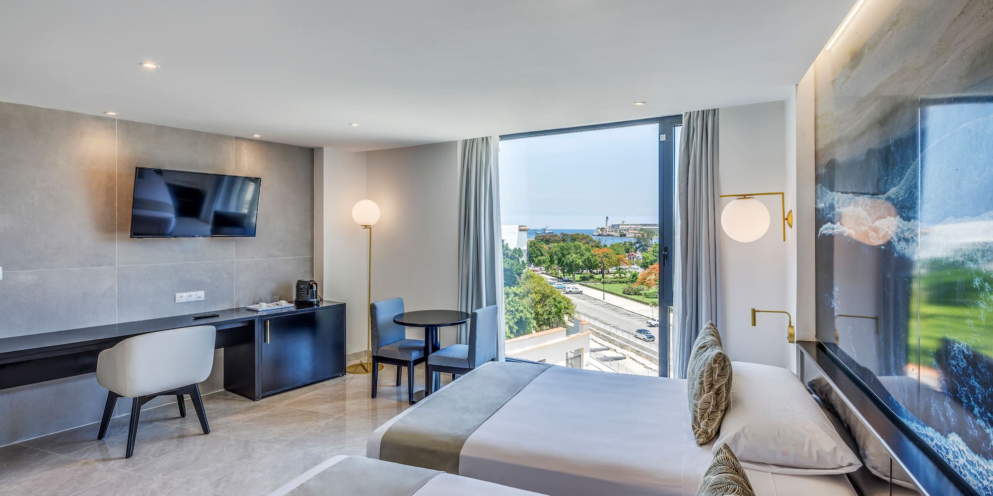 a room with two beds and a television