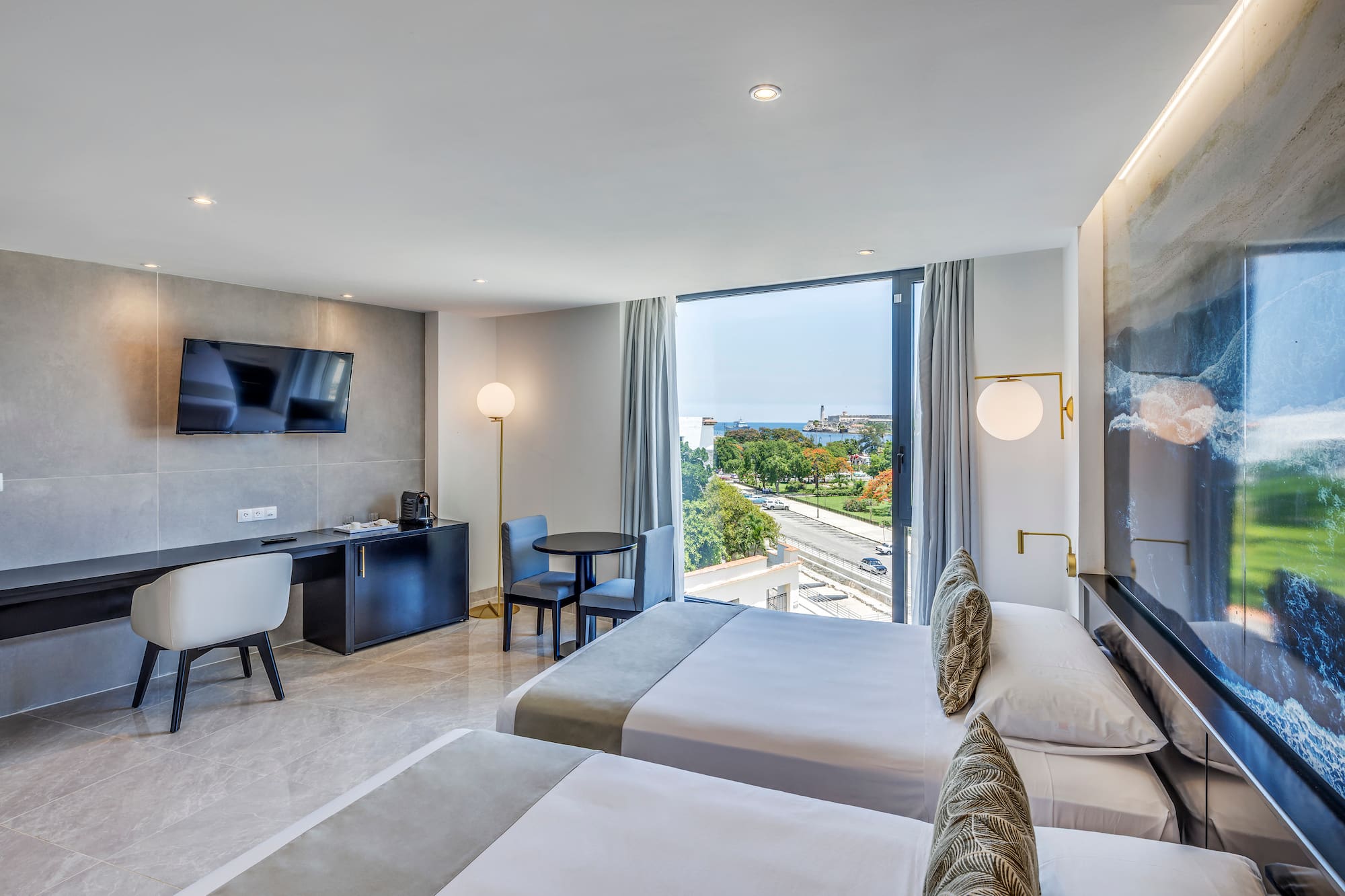 a room with two beds and a television