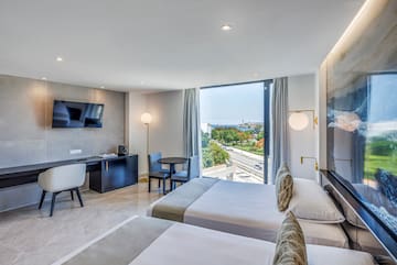 a room with two beds and a television