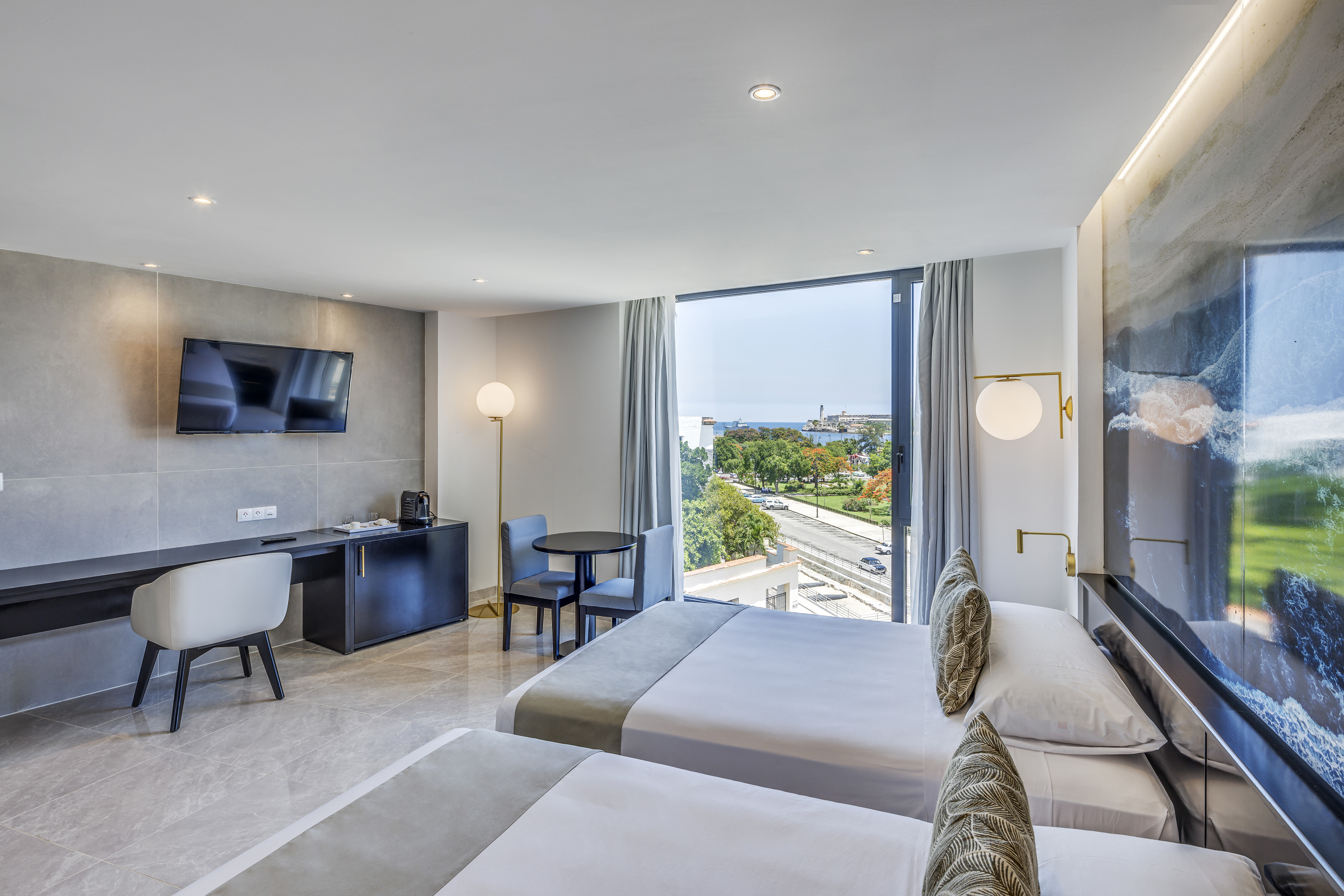 a room with two beds and a television