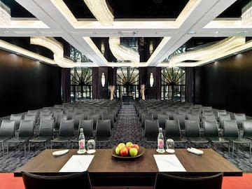 a room with chairs and a table with fruit on it