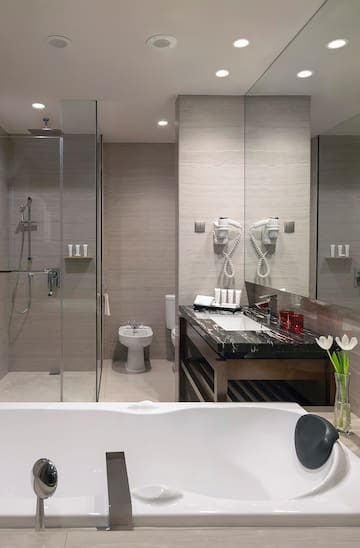 a bathroom with a bathtub and shower
