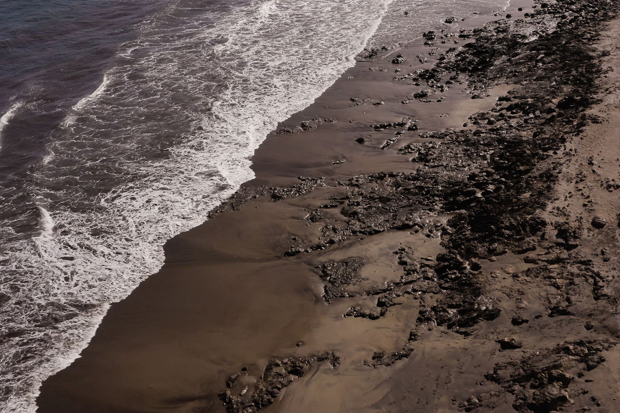 a beach with waves crashing on the shore