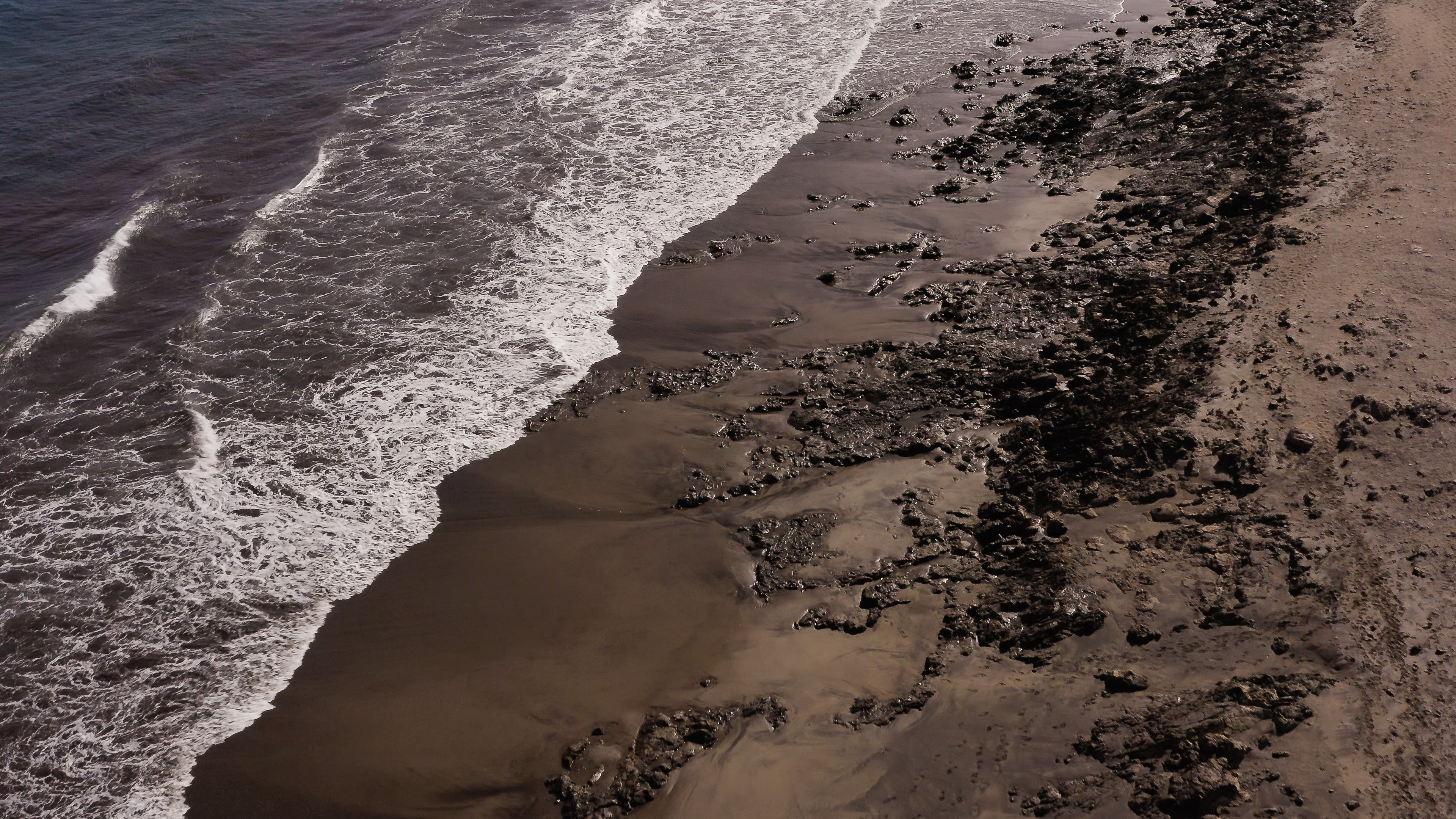a beach with waves crashing on the shore
