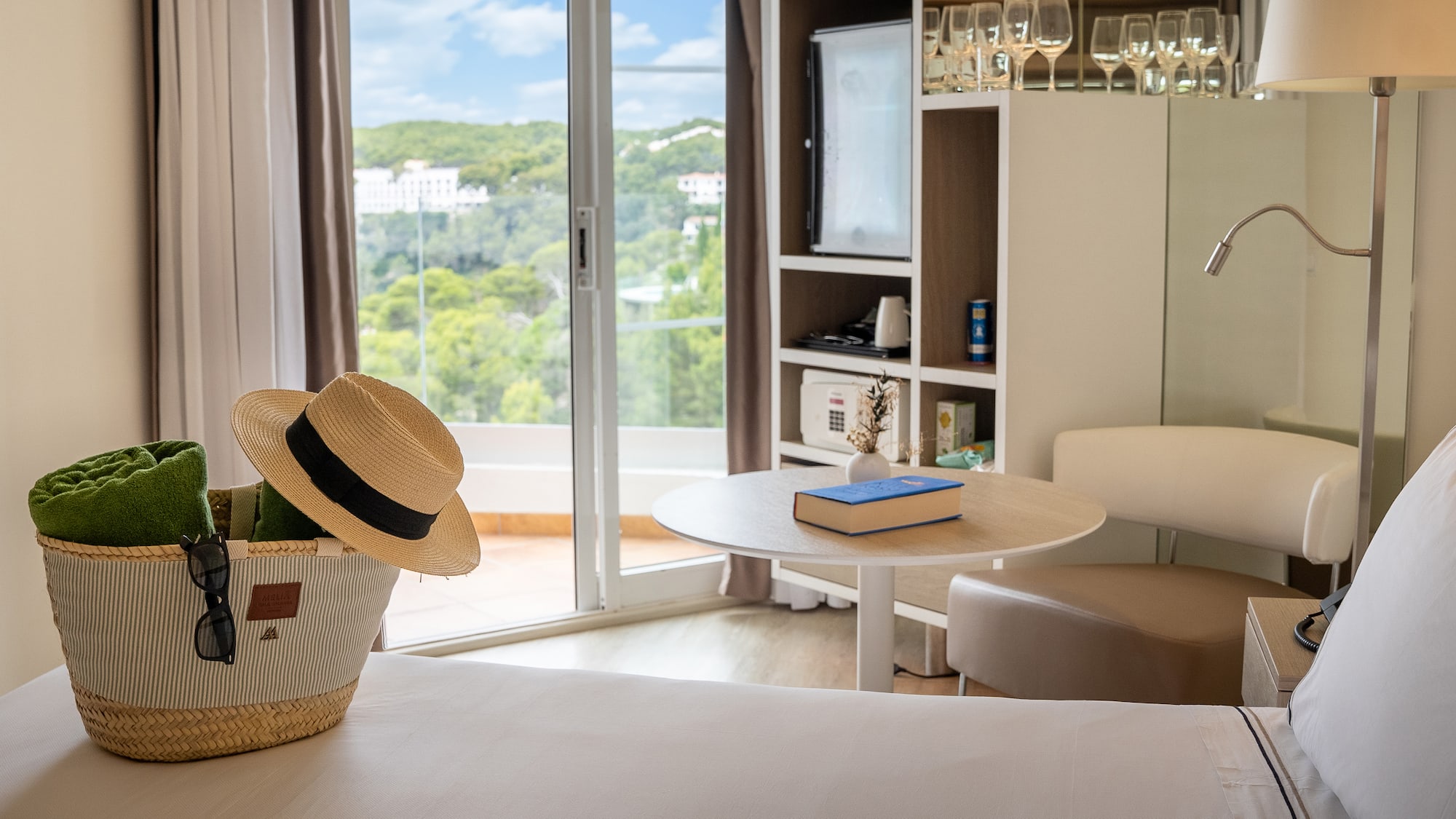 a room with a table and chairs and a book and a basket