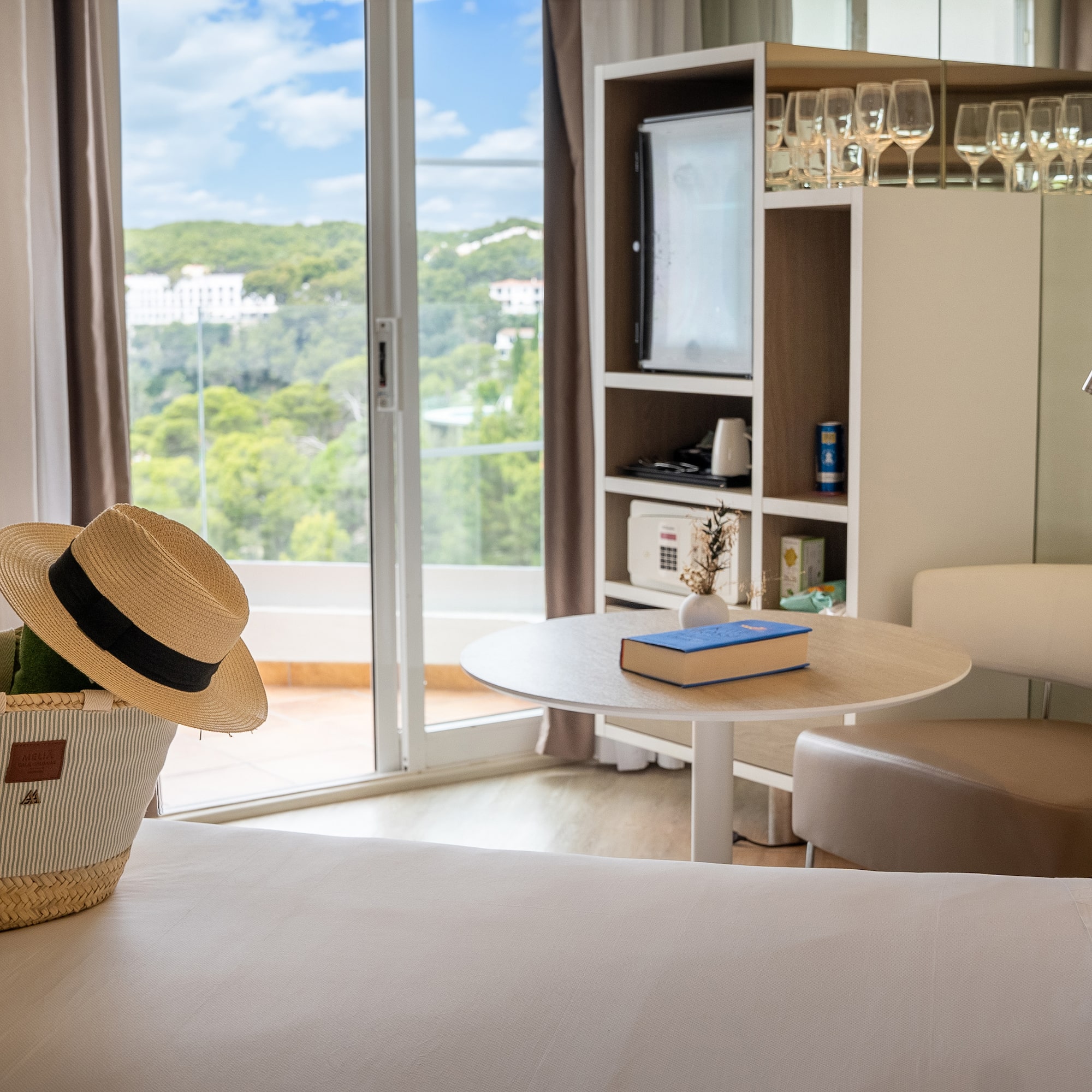 a room with a table and chairs and a book and a basket