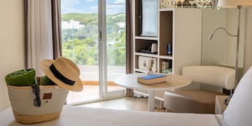 a room with a table and chairs and a book and a basket