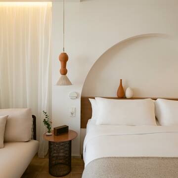 a bed with pillows and a couch in a room
