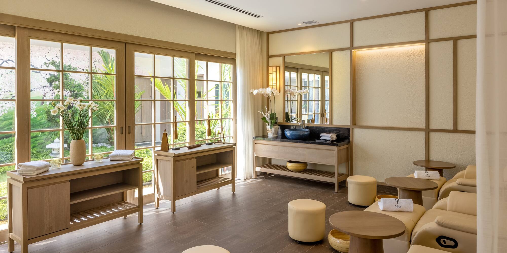 a room with a large mirror and tables