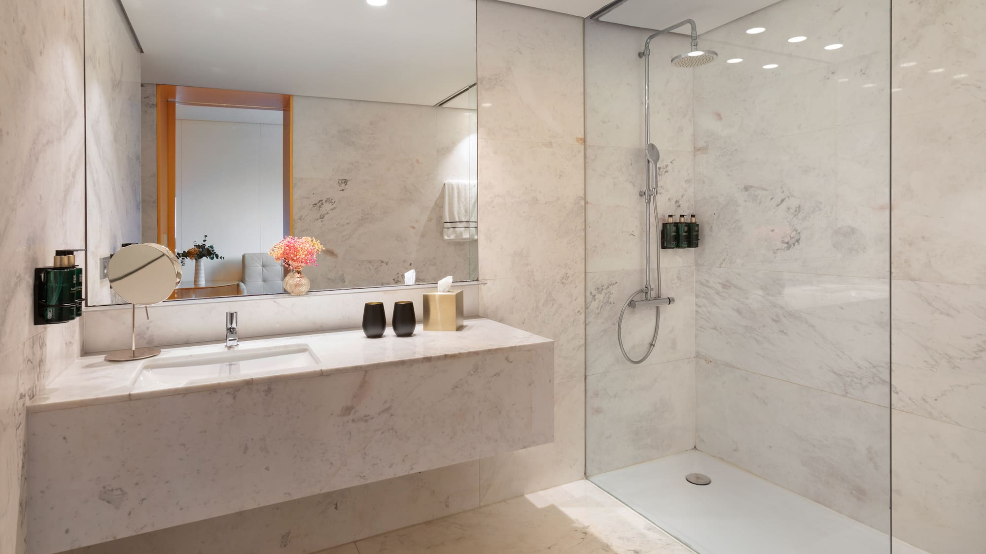a bathroom with a marble countertop and shower