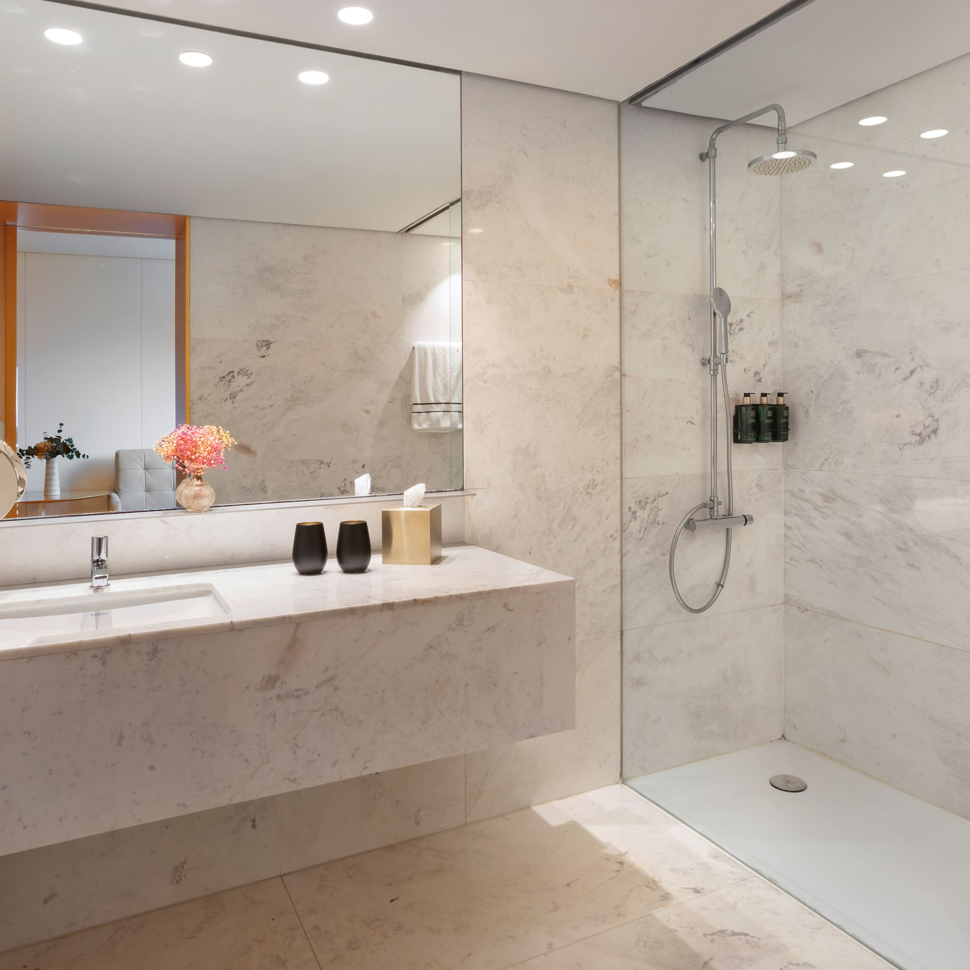 a bathroom with a marble countertop and shower