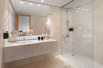 a bathroom with a marble countertop and shower