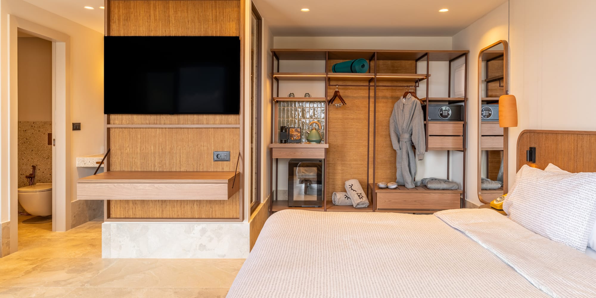 a bedroom with a tv and a closet