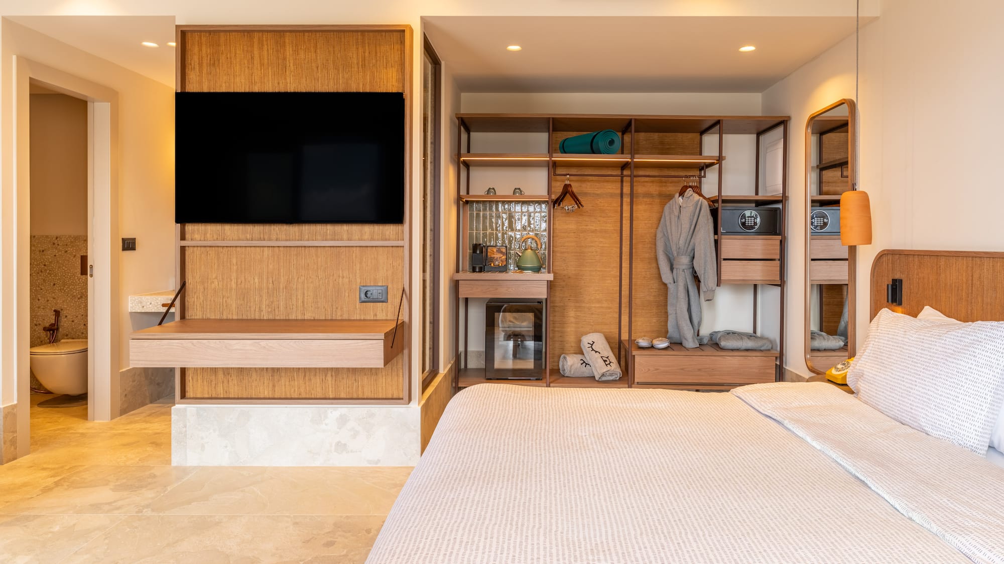 a bedroom with a tv and a closet