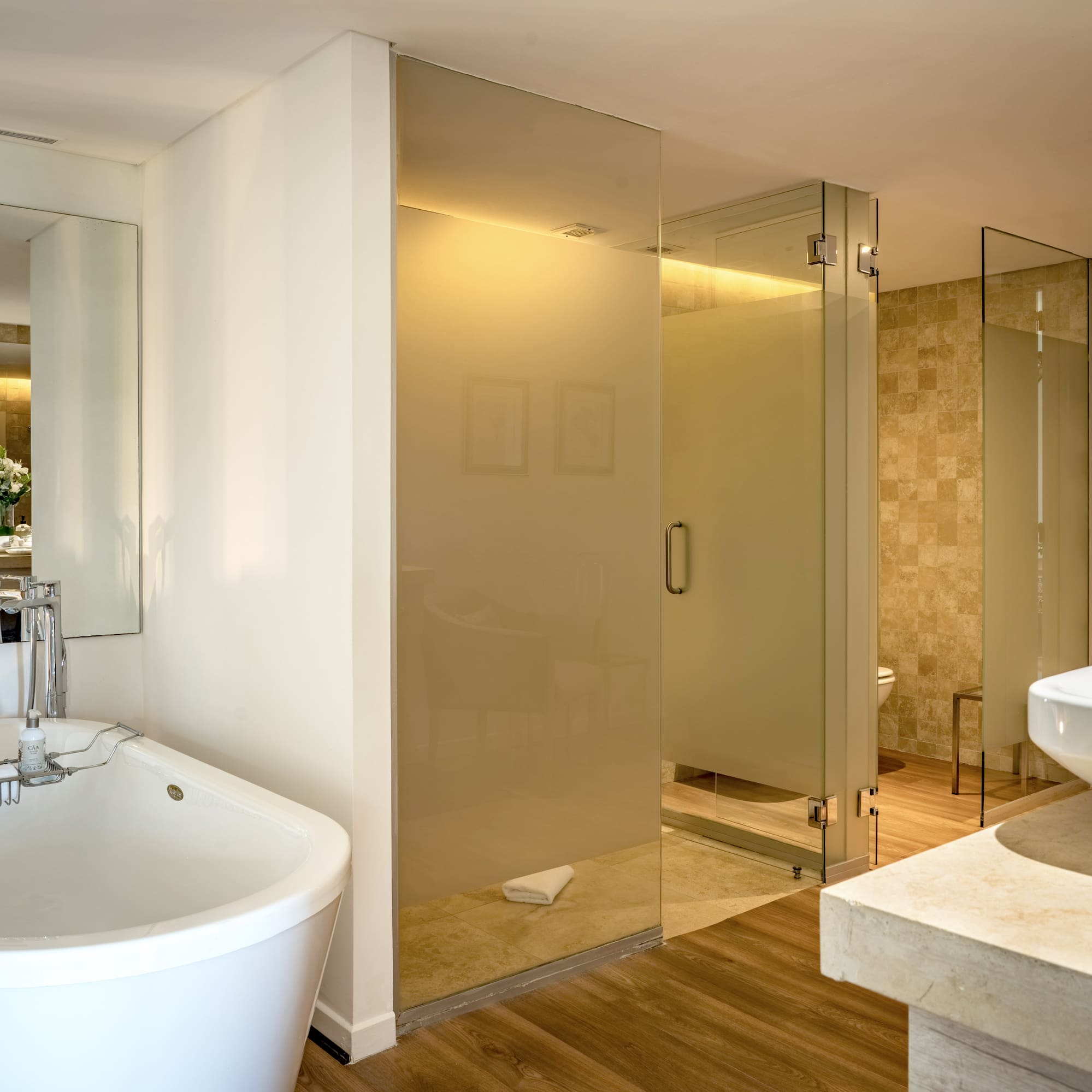 a bathroom with a large glass shower and sink