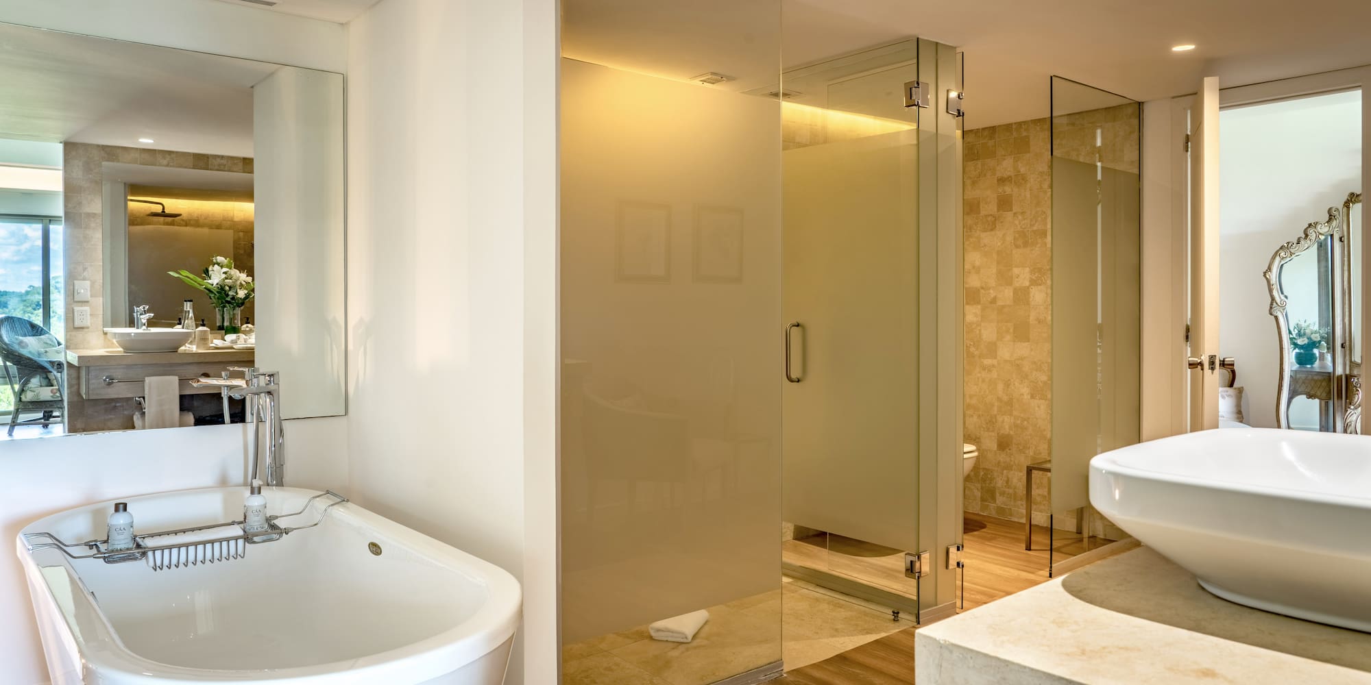 a bathroom with a large glass shower and sink
