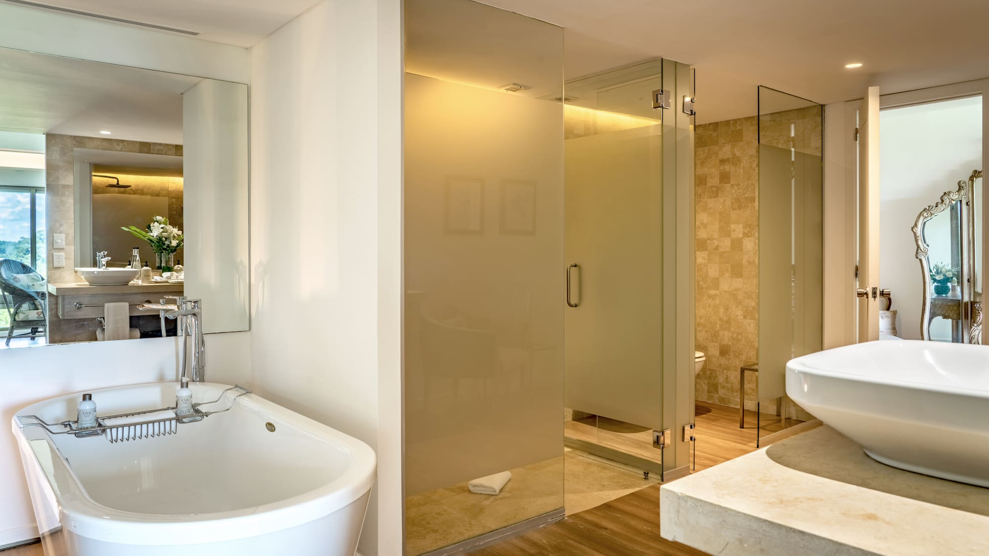 a bathroom with a large glass shower and sink