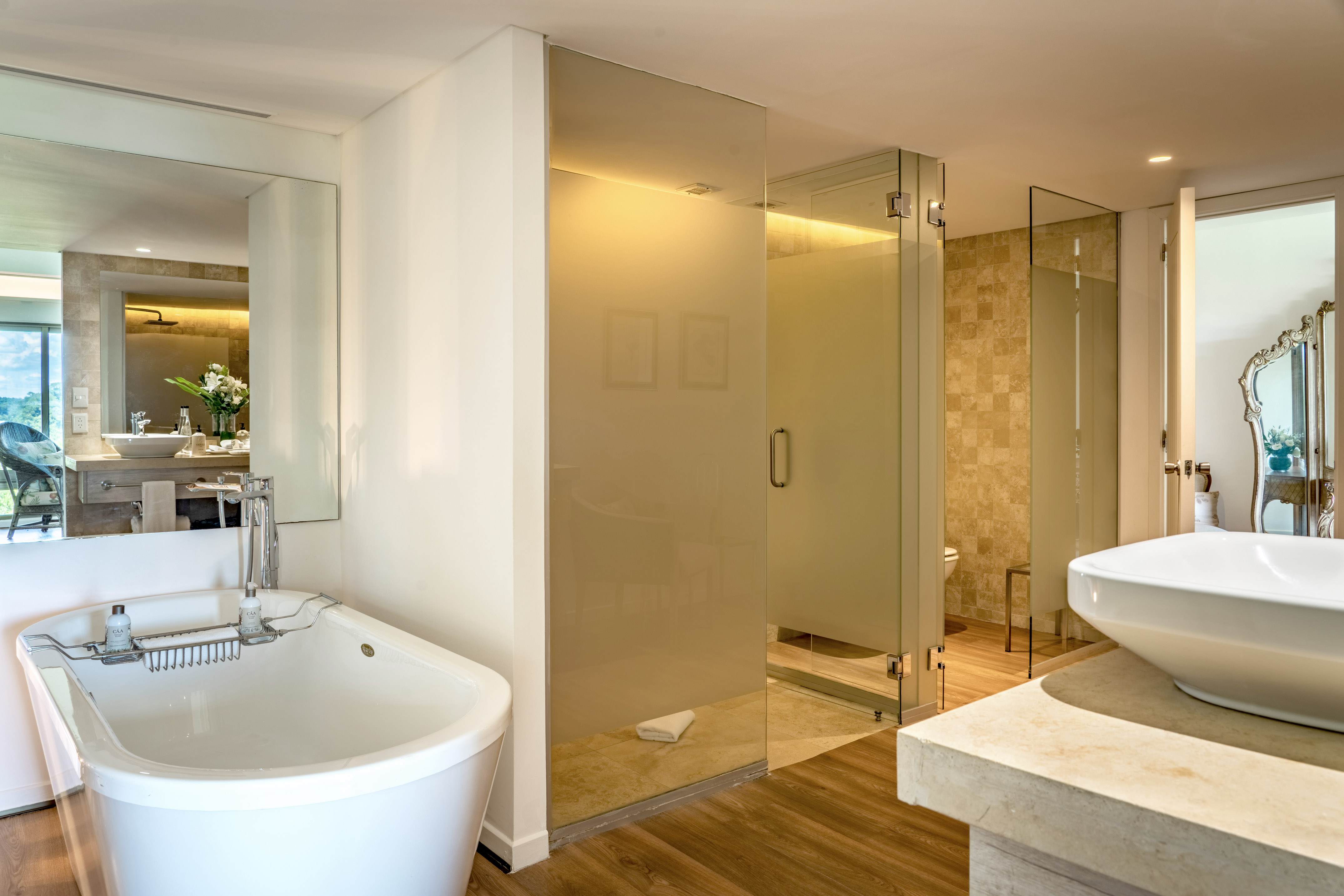 a bathroom with a large glass shower and sink