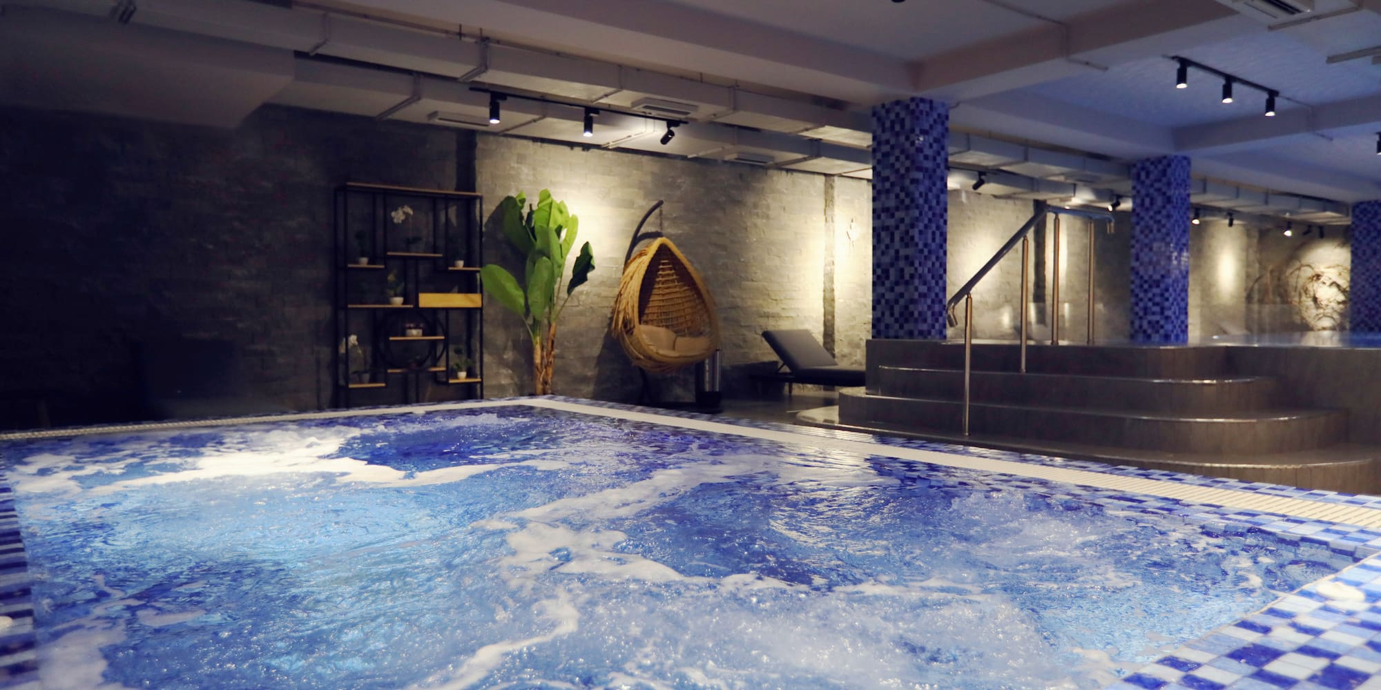 a large indoor pool with a hammock