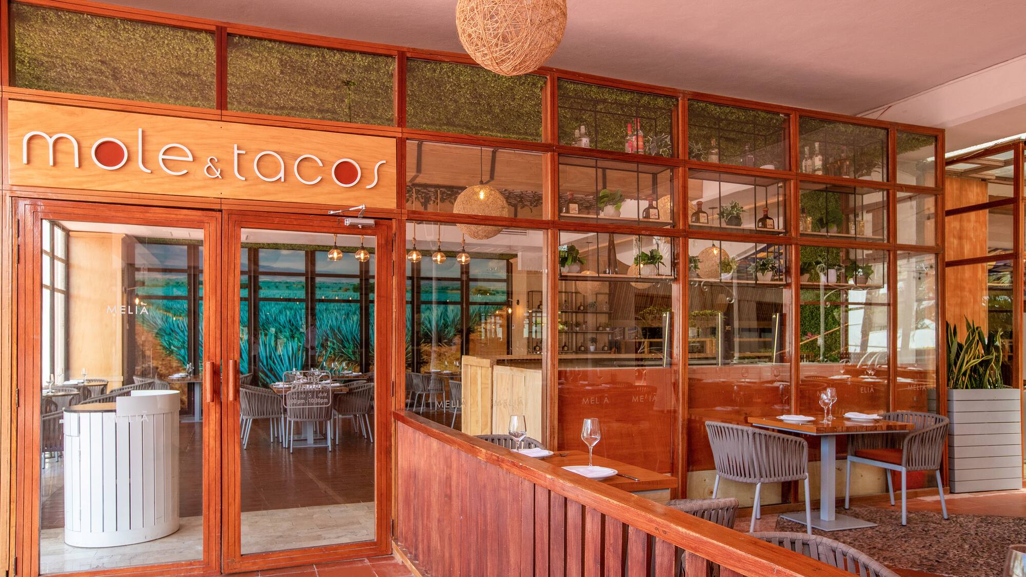 a restaurant with a glass wall and tables