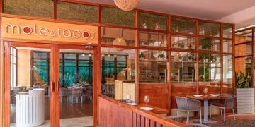 a restaurant with a glass wall and tables