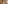 Elegant hotel suite with king bed, neutral tones, and bright patio view.