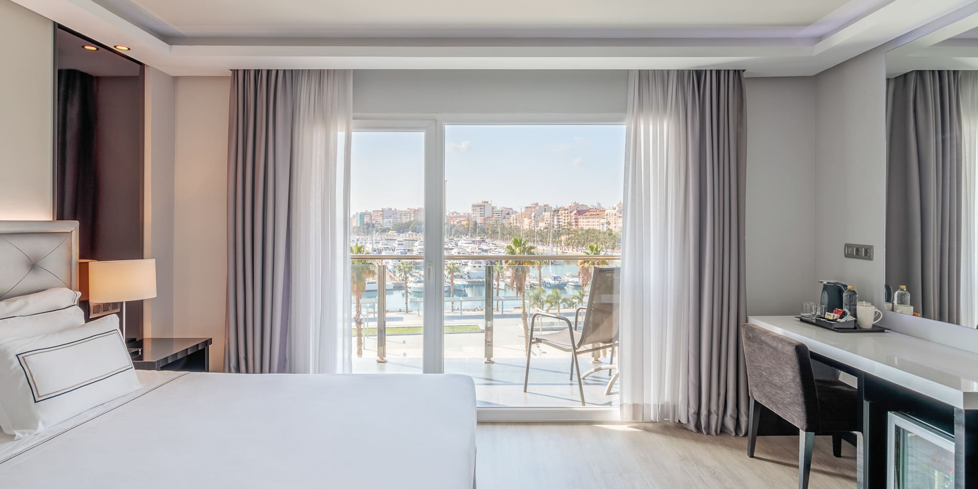 a room with a bed and a desk and a window