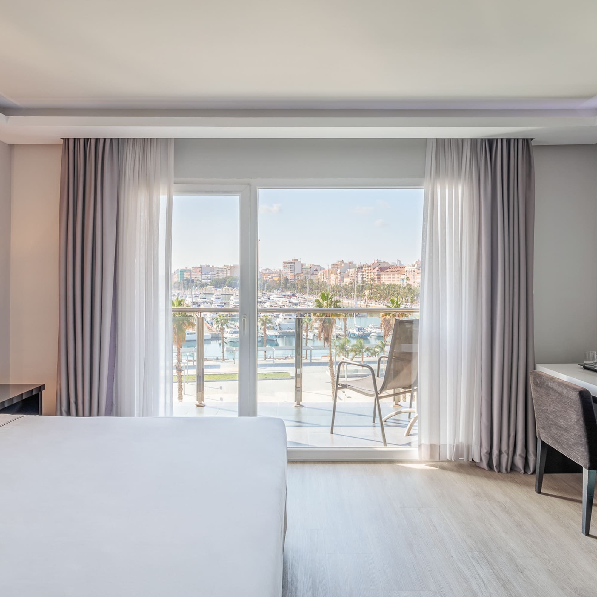 a room with a bed and a desk and a window