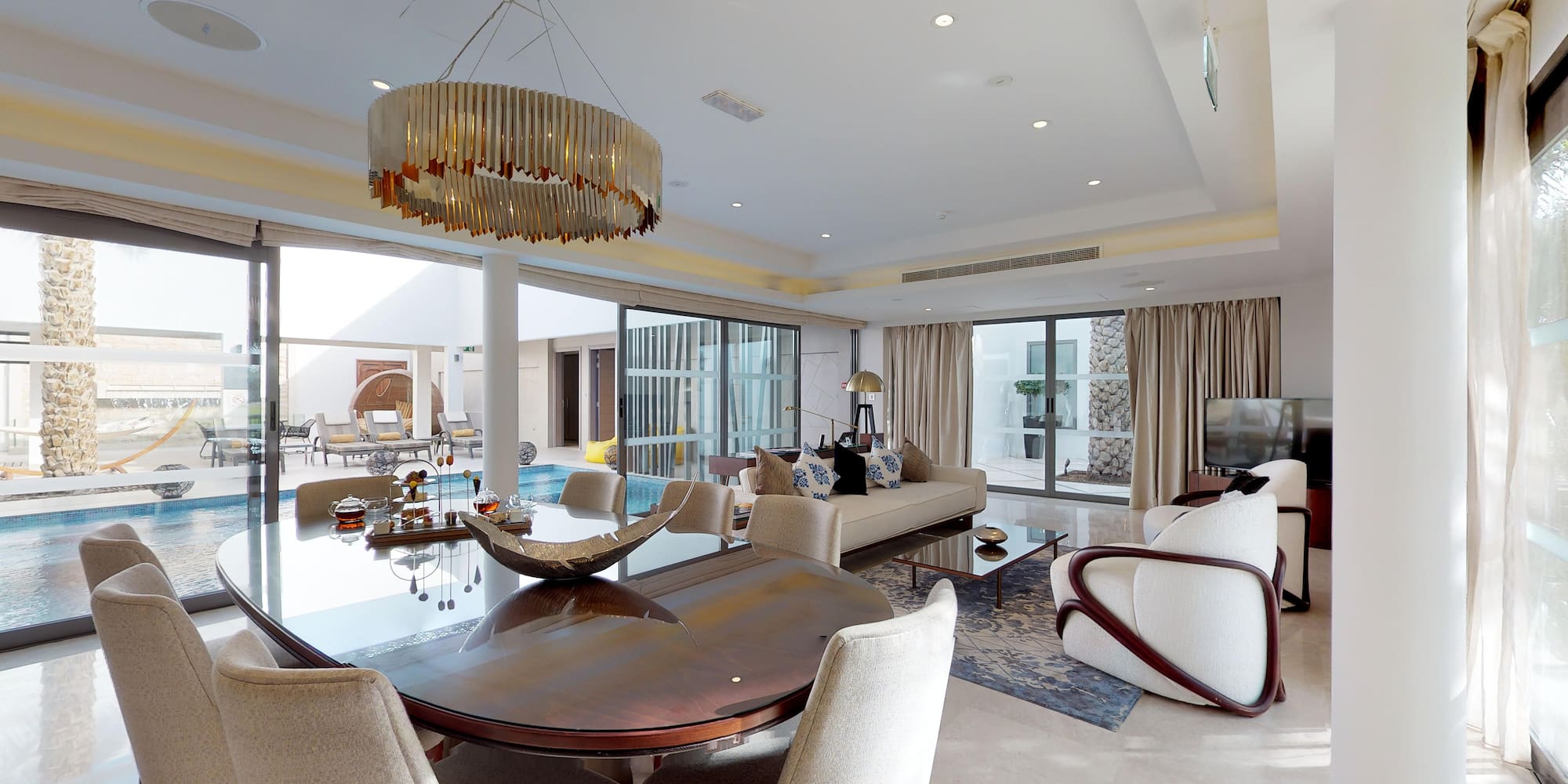 a living room with a large table and chairs